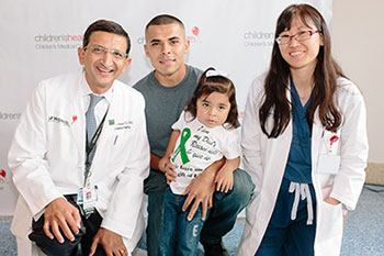 Aliyah with her father and two doctors