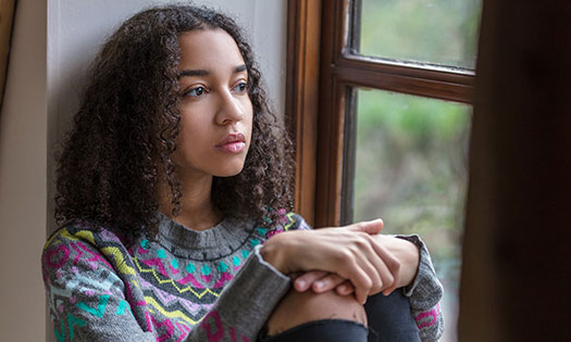 Young girl looking out the window.
