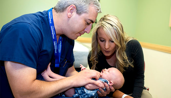 cleft lip and palate doctor with infant patient and mother