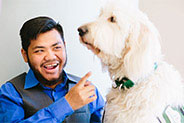 boy pointing at dog