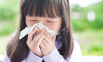 Little girl blows her nose