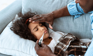 Father checking daughters temp