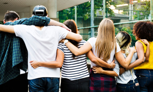 teens holding each other by the shoulder